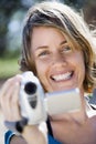 Woman with video camera. Royalty Free Stock Photo