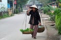 Woman in Vietnam wearing traditional triangular straw palm hats Royalty Free Stock Photo