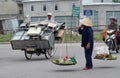 Woman in Vietnam wearing traditional triangular straw palm hats