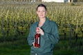 woman vineyard worker holding bottle wine Royalty Free Stock Photo