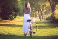 Woman with a vintage bicycle in sunset light Royalty Free Stock Photo