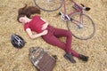 Woman with vintage bike , backbag and helmet in hay