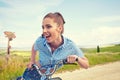 Woman with vintage bike in a country road.