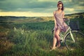 Woman with vintage bike outdoor, summer Tuscany