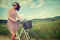 Woman with vintage bike outdoor, summer Tuscany