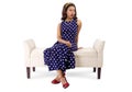 Woman in Vintage Dress and Furniture Looking Bored