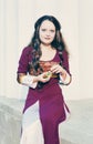 Woman in vintage dress with little bottle