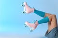 Woman with vintage roller skates on color background Royalty Free Stock Photo