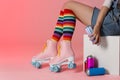 Woman with vintage roller skates and spray paint cans on color background. Space for text Royalty Free Stock Photo