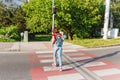 Woman violates the traffic rules and runs across the street by a red traffic light