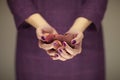 Woman in violett 50`s dress hands holding some lichees