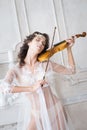 Woman with violin in white peignoir. Boudoir. seductive Royalty Free Stock Photo
