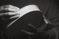 violin maker luthier hands roughing the edges of a raw blank violin with sandpaper