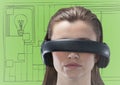 Woman in virtual reality headset against green and grey hand drawn wall with pictures Royalty Free Stock Photo