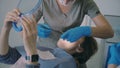 Woman visiting the dentist. Female lying on dental chair and holding the mirror. Orthodontist checks-up the overbite.