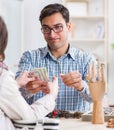 Woman visiting jeweler for jewelery evaluation