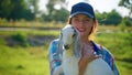 woman visitor of farm is holding little boer goat , ecotourism in cattle farm