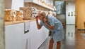 Woman visitor in historical museum looking at art object.