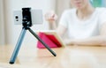 Woman vlogger looking using ipad computer and filming Royalty Free Stock Photo