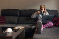 Woman in voluntary confinement with pajamas and surgical mask for prevention of coronavirus covid19 virus. She works at home using Royalty Free Stock Photo