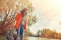 A woman volunteer on a scavenger hunt on the river. Trees and a river in the background. The concept of environmental protection. Royalty Free Stock Photo