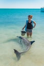 Monkey Mia, Nov 2019: Woman volunteer holding bucket with fish