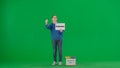 A woman volunteer waves her hand, showing the gesture come here on the green screen. Woman holding a poster with the Royalty Free Stock Photo