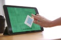 Woman voting online via tablet indoors, closeup