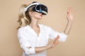 Woman with VR glasses of virtual reality. Young girl in virtual augmented reality helmet. VR headset. Royalty Free Stock Photo