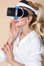 Woman with VR glasses of virtual reality. Young girl in virtual augmented reality helmet. VR headset. Royalty Free Stock Photo