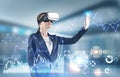 Woman in VR glasses working with infographics, hud Royalty Free Stock Photo