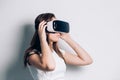 Woman in VR headset looking up at the objects in virtual reality. Royalty Free Stock Photo