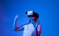 Woman in VR headset looking up at the objects in virtual reality. Young woman using VR glasses. Virtual reality headset. Royalty Free Stock Photo