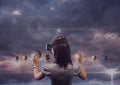 Woman in VR headset touching 3D planets against purple sky with clouds and flares