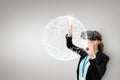 Woman in VR headset touching 3D sphere against white background Royalty Free Stock Photo