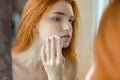 Woman with wadding looking at her reflection in mirror