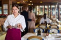 Woman waiter demonstrating her upset with small tip