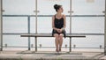 Woman waiting for a bus at the bus stop looks around and misses