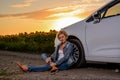 Woman waiting beside her car on a rural road Royalty Free Stock Photo