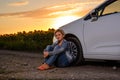 Woman waiting beside her car on a rural road Royalty Free Stock Photo