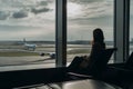 Woman waiting room airport view. Generate Ai Royalty Free Stock Photo