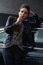 Woman, waiting and smoking cigarette on car in parking lot for pick up or transportation. Female person, smoker or Royalty Free Stock Photo