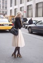 A woman waiting to cross the street at Lincoln Center