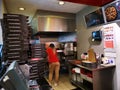 Woman waiting to pizza out of the oven at Pizza Hut DeliveryÃ¢â¬Å½ indoor