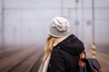 Woman waiting for train on empty railway station Royalty Free Stock Photo