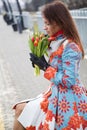 Woman waiting train look at flowers Royalty Free Stock Photo