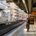 A woman waiting for the train at station in Kamakura, Japan