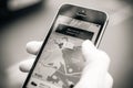 Woman waiting for the uber car on the street holding smartphone Royalty Free Stock Photo