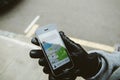 Woman waiting for the uber car on the street holding smartphone Royalty Free Stock Photo