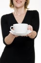 Woman/waitress offering tea/coffee Royalty Free Stock Photo